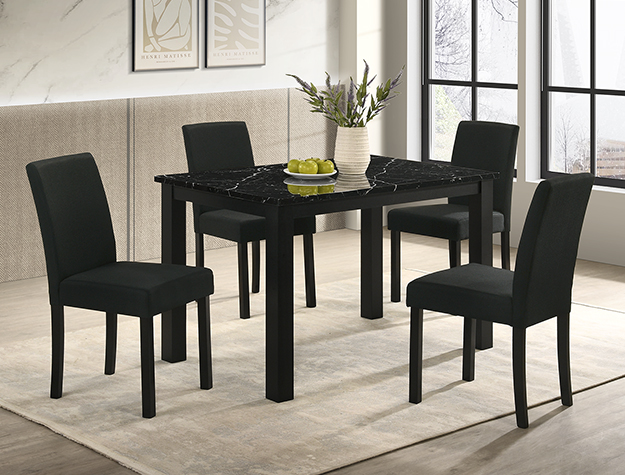A modern dining room featuring the "Resia" Dining Set in Black (#2120BK) with a marble-top table, four black upholstered chairs, a beige rug, floral vase, bowl of green apples, and large windows streaming natural light.