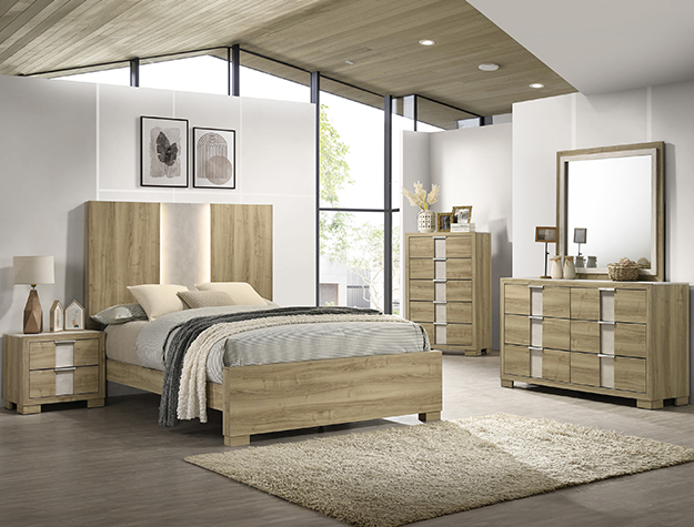 The "Rangley" Bedroom in Driftwood (#B6832) features a bed, two nightstands, a tall dresser, wide dresser with mirror, and neutral bedding. Large windows, wall art, and a beige rug create a bright, airy modern retreat.