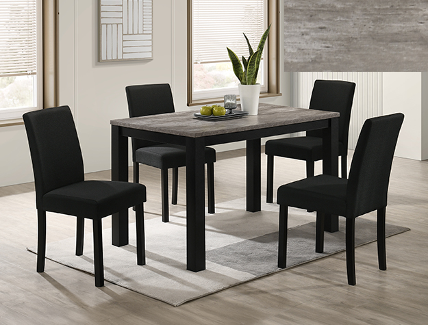 Modern dining room with a rectangular table and four black chairs on a light gray rug. A potted plant and fruit bowl adorn the table, set in a bright room with large windows.