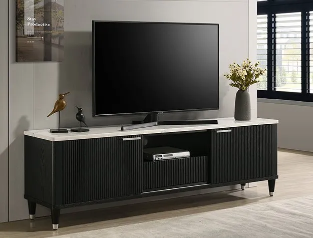 A modern living room features a large, flat-screen TV on a sleek black media console. A decorative bird sculpture and a vase with flowers sit on top.